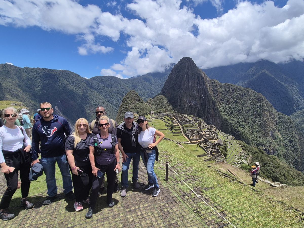 Anders Languages guests at Machu Picchu, with the Inca citadel and Huayna Picchu behind them